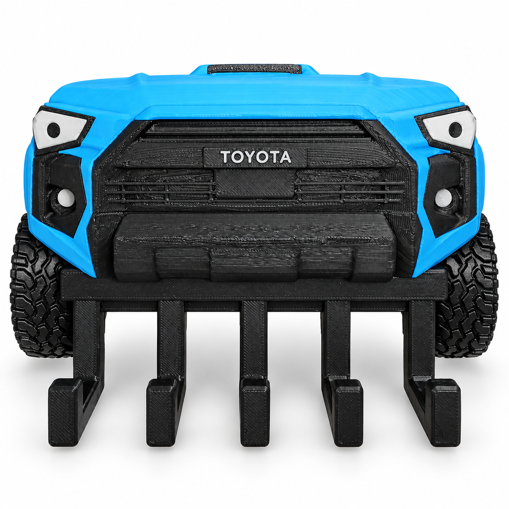Blue 5th Gen Toyota 4Runner style wall key hanger with five black hooks, off-road tires and black grille on a clean studio background